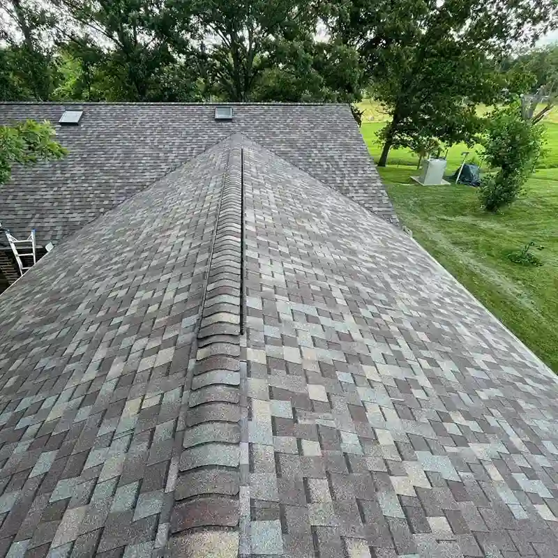 New gray shingles installed by Hollis Roofing & Restoration on a home